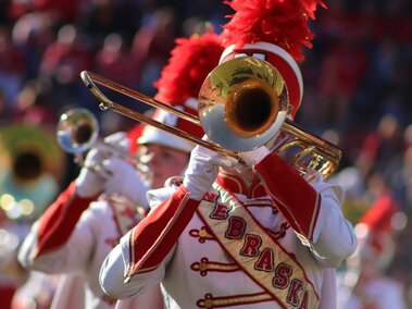 CMB trombone player with trumpet player in the background performing in Memorial Stadium